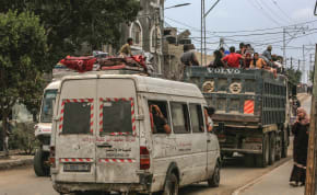 PALESTINIANS FLEE Rafah with their belongings, May 28. 