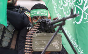  Palestinian Hamas terrorists take part in a rally during the 35th anniversary of Hamas founding, in Khan Younis in the southern Gaza Strip, December 14, 2022. 