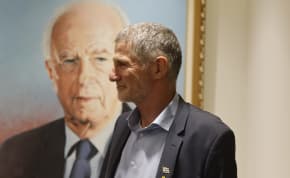  Labor leader Yair Golan poses next to a photo of former prime minister Yitzhak Rabin, June 17, 2024