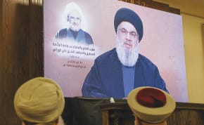  HEZBOLLAH LEADER Hassan Nasrallah delivers a video address, watched at an event in Beirut’s southern suburbs, last month.