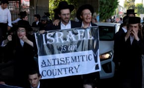  Ultra-Orthodox Jewish men protest following the Israeli Supreme Court ruling that requires the state to begin drafting ultra-Orthodox Jewish seminary students to the military, in Bnei Brak, Israel, June 27, 2024. 