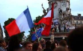  People hold French national flags as they gather to protest against the French far-right Rassemblement National (National Rally - RN) party, at the Place de la Republique following partial results in the first round of the early 2024 legislative elections, in Paris, France, June 30, 2024. 