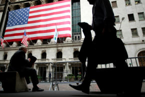 Morning commuters are seen outside the New York Stock Exchange.