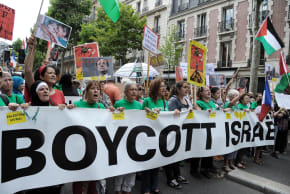 Protesters hold abanner that reads "Boycott Israel" during a pro-Palestinian demonstration in Paris