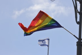  The LGBTQ+ rainbow flag is seen flying along with the flag of Israel during Gay Pride Parade