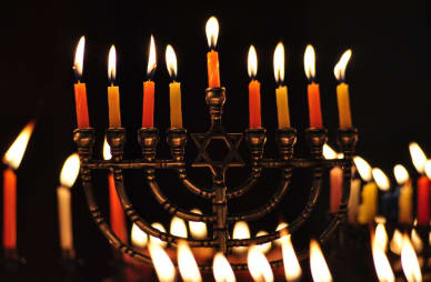  A Hanukkah menorah with lit candles.