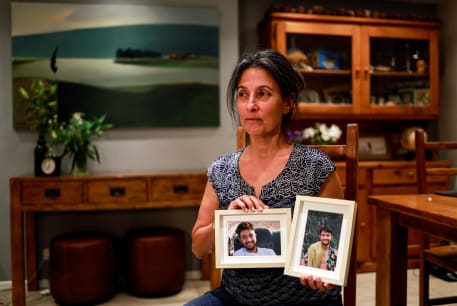  Rachel Goldberg, U.S.-Israeli mother of Hersh Goldberg Polin, which was taken hostage by Hamas militants into the Gaza Strip while attending a music festival in south Israel, holds photos of her son in their home in Jerusalem October 17, 2023