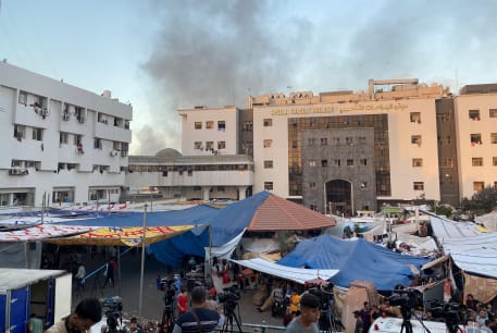  Smoke rises as displaced Palestinians take shelter at Al Shifa hospital, amid the ongoing conflict between Hamas and Israel, in Gaza City, November 8, 2023.