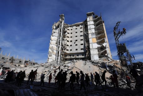  Palestinians gather near a building damaged in an Israeli airstrike in Rafah, in the southern Gaza Strip March 9, 2024