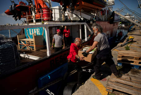  Open Arms members carry humanitarian aid for Gaza in a joint mission between NGOs Open Arms and World Central Kitchen at a port of Larnaca, Cyprus, March 9, 2024. 