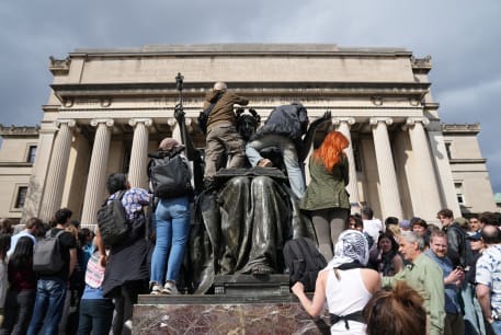  People climb the Alma Mater statue to see the speaker of the U.S. House of Representatives Mike Johnson (R-LA) during a press conference at Columbia University in response to demonstrators protesting in support of Palestinians, amid the ongoing conflict between Israel and the Palestinian Islamist g