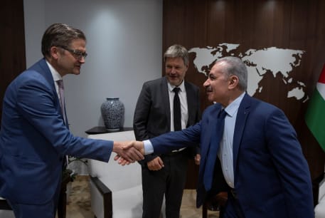  Palestinian Prime Minister Mohammad Shtayyeh shakes hands with the Head of Representative Office of the Federal Republic of Germany in the Palestinian territories, Oliver Owcza, while he receives German Vice-Chancellor Robert Habeck, at his office in the West Bank city of Ramallah, June 7, 2022.