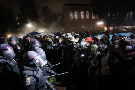  Law enforcement officials clash with demonstrators, as they try to enter the protest encampment in support of Palestinians at the University of California Los Angeles (UCLA), May 2, 2024