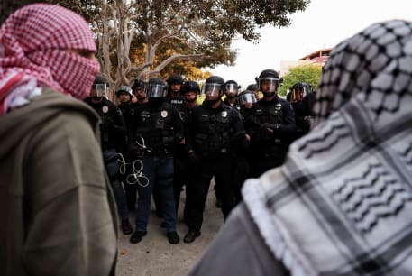  Law enforcement officers deployed to the University of California, Irvine (UC Irvine) stand guard, after protesters against the war in Gaza surrounded the physical sciences lecture hall, as the conflict between Israel and Hamas continues, in Irvine, California, US, M