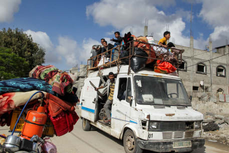  Displaced Palestinians travel in a vehicle as they flee Rafah, after Israeli forces launched a ground and air operation in the eastern part of southern Gaza city, amid the ongoing conflict between Israel and Hamas, in Rafah, in the southern Gaza Strip May 12, 2024.