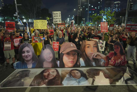  Demonstrators hold images of five female soldiers held hostage by Hamas terrorists in Gaza, as they protest calling for the release of all hostages held in the Gaza Strip and against the current Israeli government outside the Ministry of Defense in Tel Aviv, May 25, 2024. 