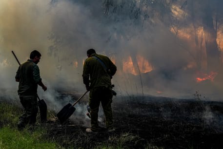  Members of an emergency squad try to extinguish a forest fire caused from rockets fired from Lebanon, near the northern Israeli town of Kiryat Shmona, June 4, 2024.