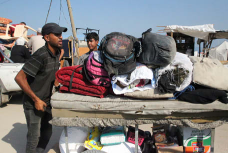  Palestinians travel on foot with their belongings as they flee Rafah due to an Israeli military operation, amid the Israel-Hamas conflict, in Rafah, in the southern Gaza Strip, June 13, 2024.