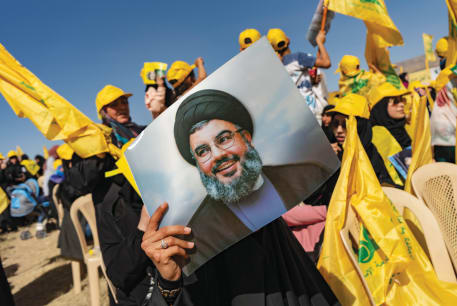  HOISTING A photo of Hezbollah Secretary-General Hassan Nasrallah at a rally in Bekaa Valley, Lebanon.