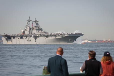  People watch as Sailors and Marines line the deck of the USS Wasp, an amphibious assault ship, as it arrives in New York Harbor during the parade of ships to kick off "Fleet Week 2023" in New York City, U.S., May 24, 2023.