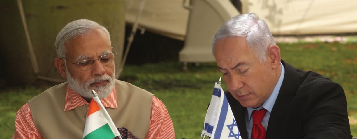 PRIME MINISTER of India Narendra Modi looks on during his 2017 visit to Israel as Prime Minister Benjamin Netanyahu signs a document of cooperation.