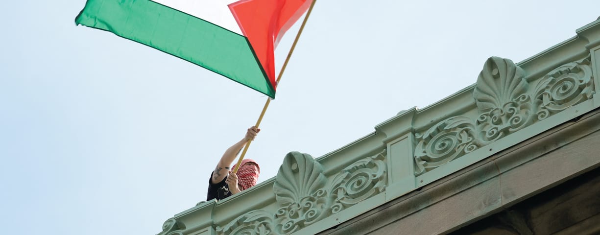  A STUDENT protester waves a Palestinian flag above Hamilton Hall on the campus of Columbia University in New York, in late April.