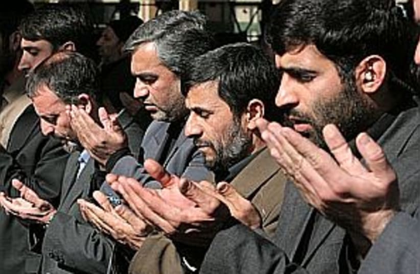 ahmadinejad prays 298 (photo credit: AP)