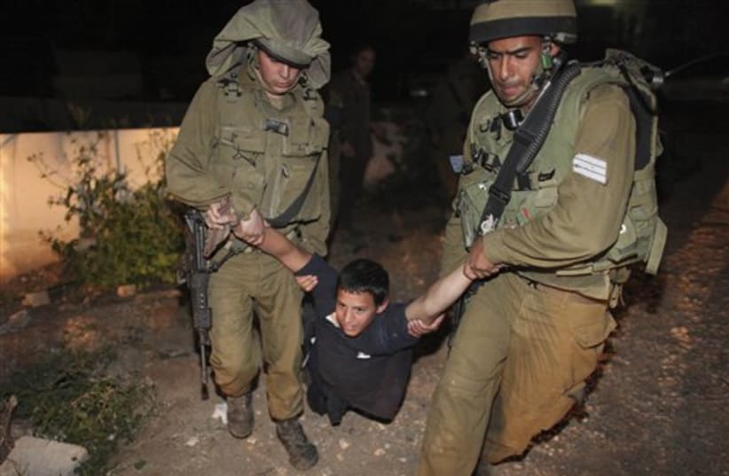 Israeli soldiers detain Jewish settler in Jericho (photo credit: AP)