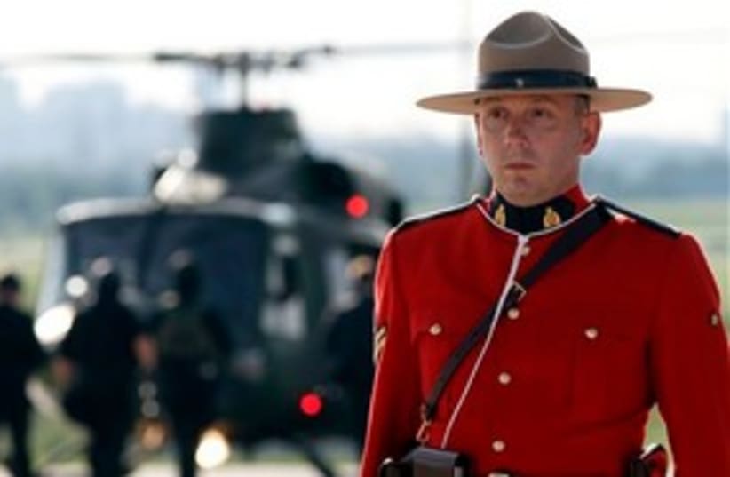 Canadian mounty by G8 helicopter 311 (photo credit: Associated Press)