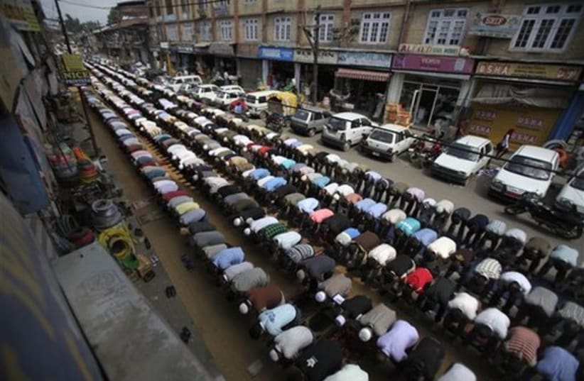  Kashmiri Muslims pray on a street on the third Friday of Ra (photo credit: AP)