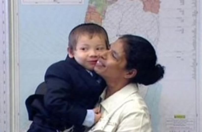 Mumbai nanny smiling with boy 311 (photo credit: Channel 10)