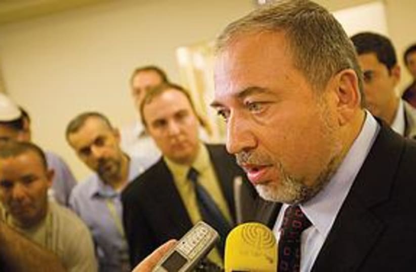 Lieberman talks to press (photo credit: Pool/Haaretz, Tal Cohen)