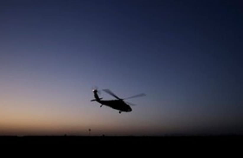 Afghan helicopter at night 311 (photo credit: AP Photo/Brennan Linsley)