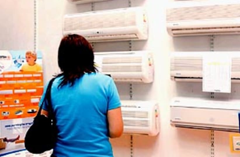 A woman shopping for air conditioners (photo credit: Ariel Jerozolimski )