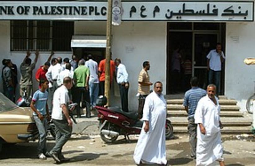 Gazans wait to draw money from an ATM of the Bank of Palesti (photo credit: ABED RAHIM KHTIB/FLASH 90)