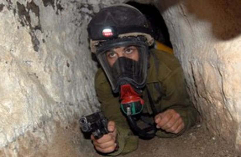 Soldier in gas mask and gun 311 (photo credit: IDF)