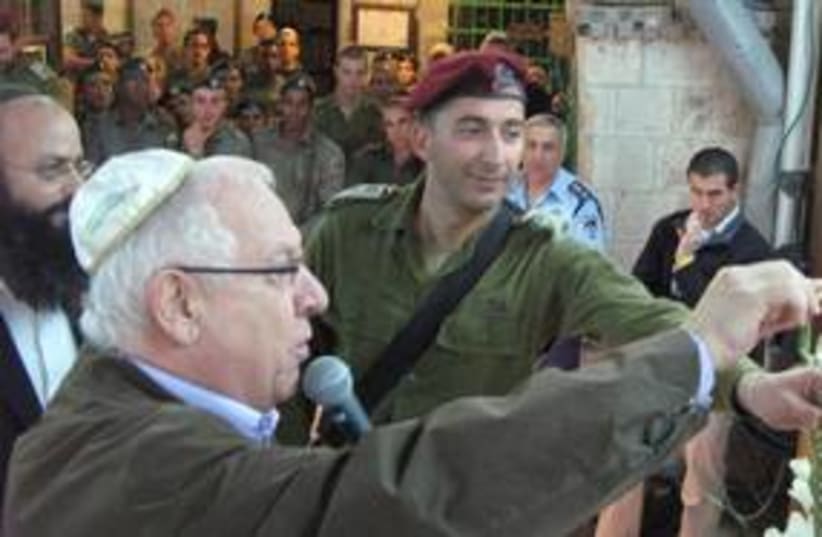 Rivlin in Hebron lighting candles 311 (photo credit: REBECCA ANNA STOIL)