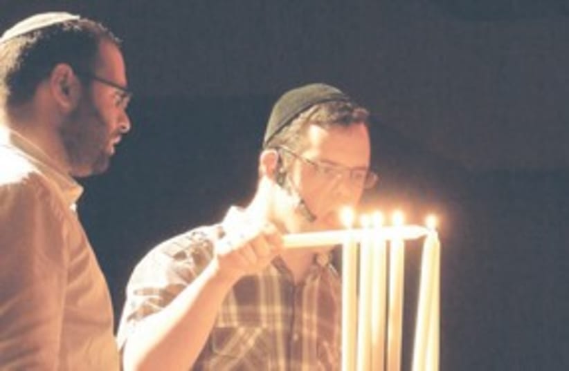 Down's Syndrom guy lighting candles  311 (photo credit: MELANIE LIDMAN)