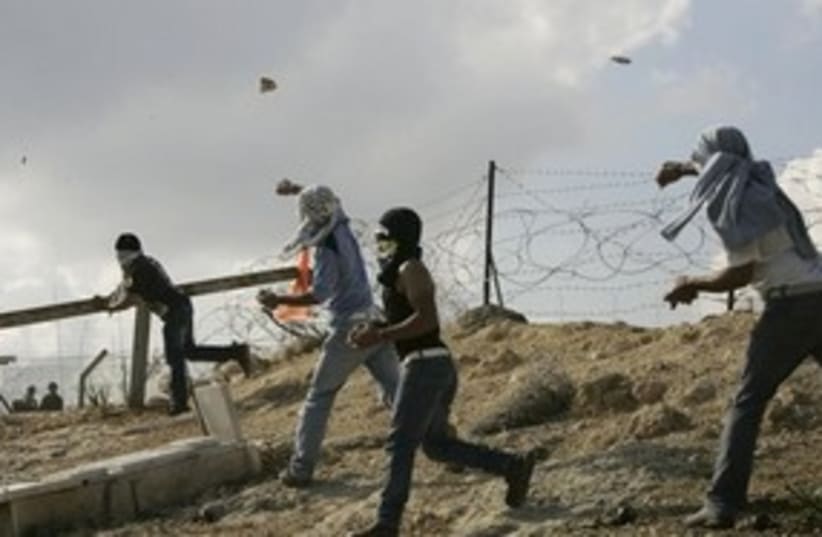 Bil'in demonstrators protestors slinging throwing rocks 311 (photo credit: AP)
