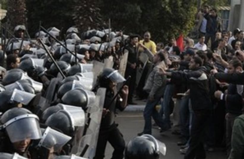 Protesters and riot police in Cairo (photo credit: Associated Press)