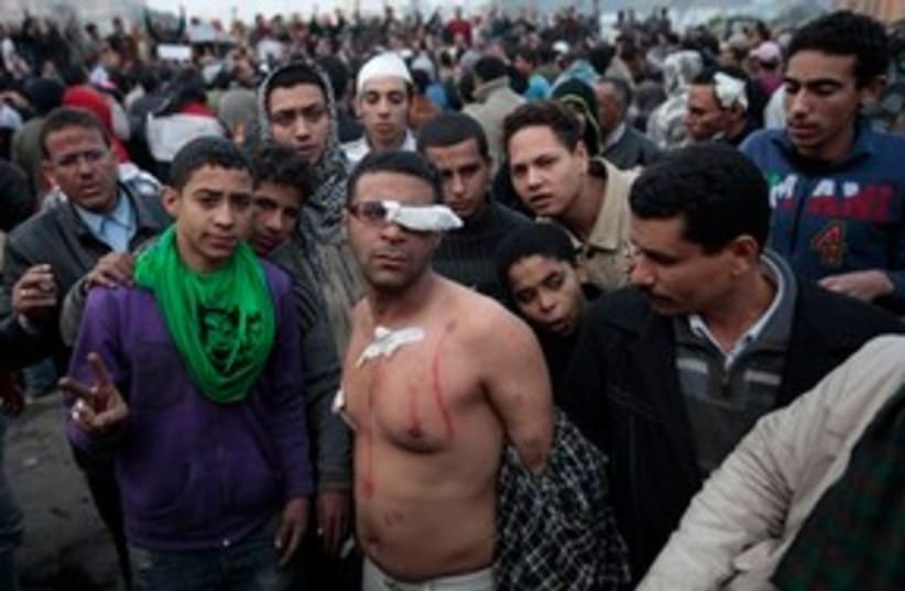 Egypt protests, topless man injured 311 (photo credit: AP Photo/Lefteris Pitarakis)