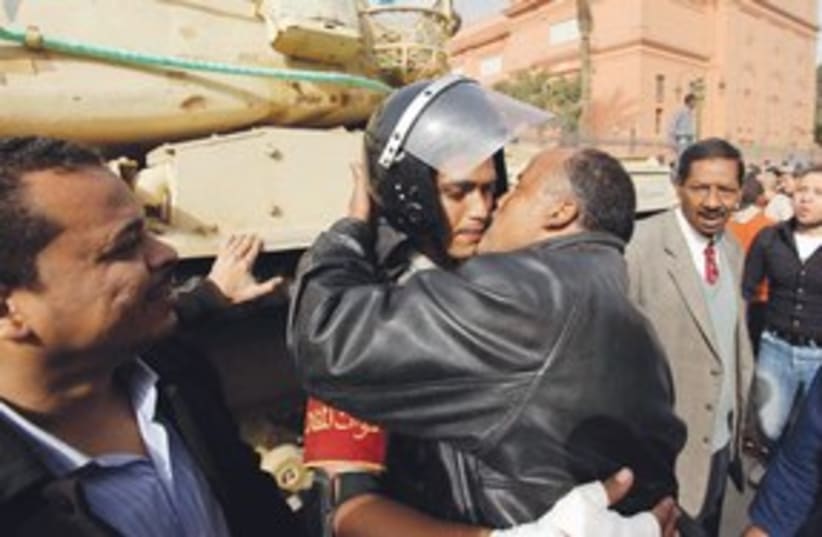 egyptian protestor kissing army officer_311 (photo credit: ASSOCIATED PRESS)