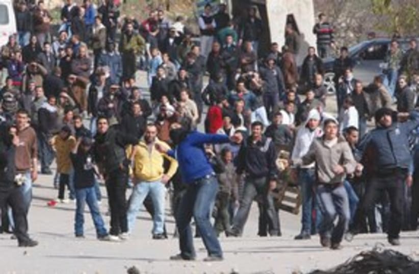 palestinians throw stones in Beit Omar_311 (photo credit: ASSOCIATED PRESS)
