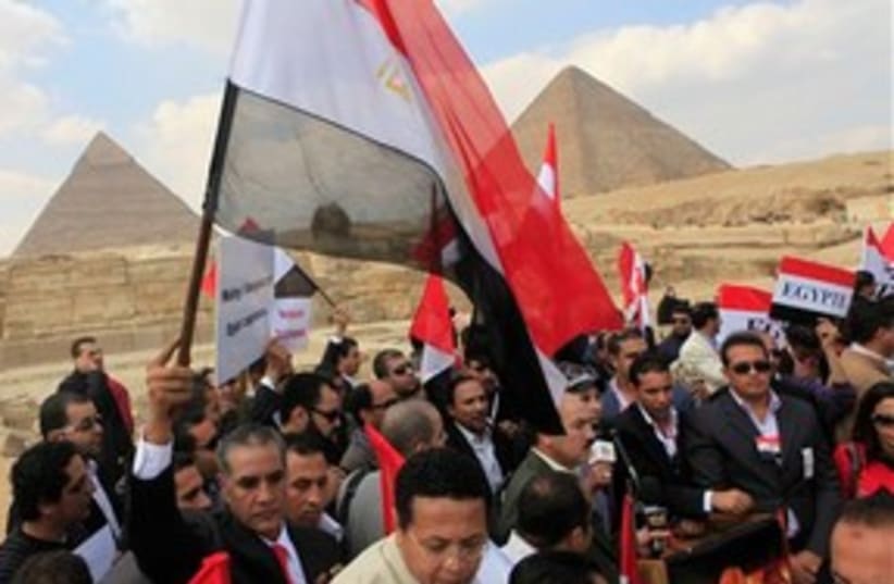 Egyptian protesters with flags at pyramids 311 (photo credit: AP Photo/Amr Nabil)