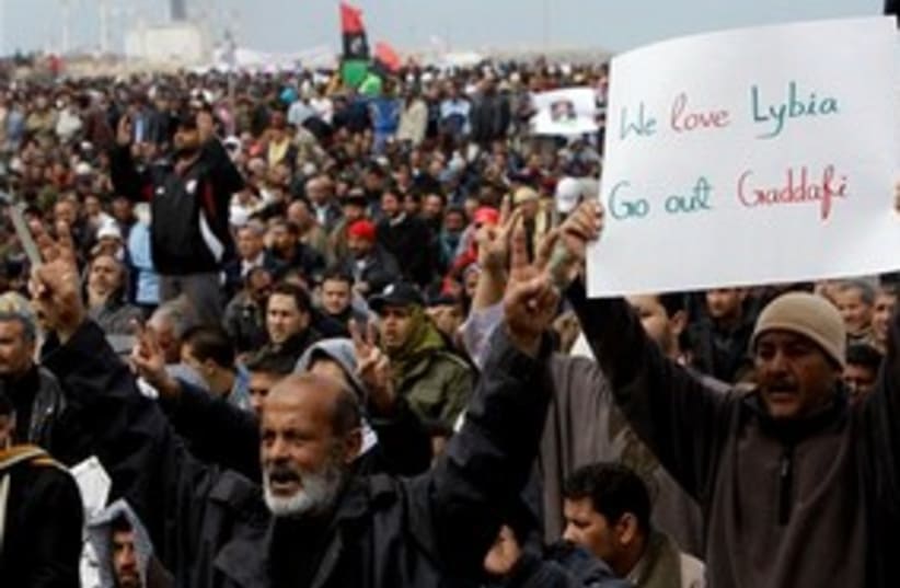 Libyan Protesters holding sign 311 (photo credit: AP Photo/Hussein Malla)