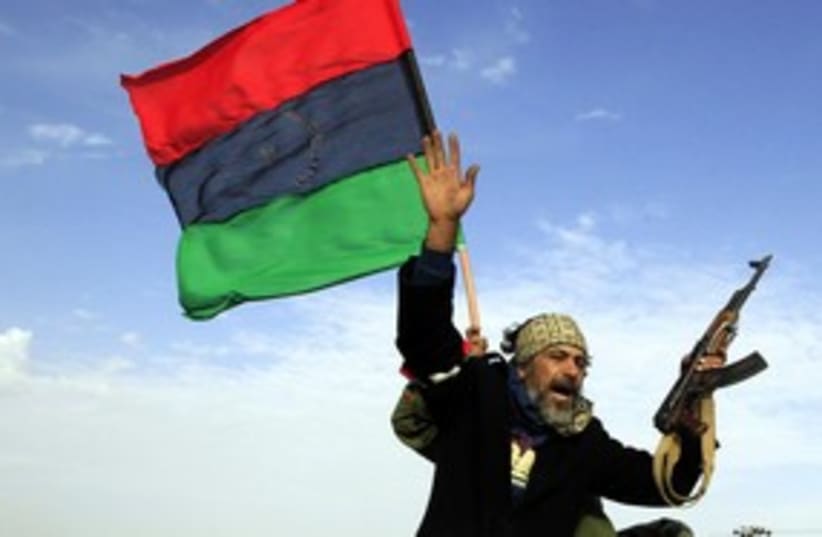 Libyan rebel waving hand (R) 311 (photo credit: REUTERS/Goran Tomasevic)