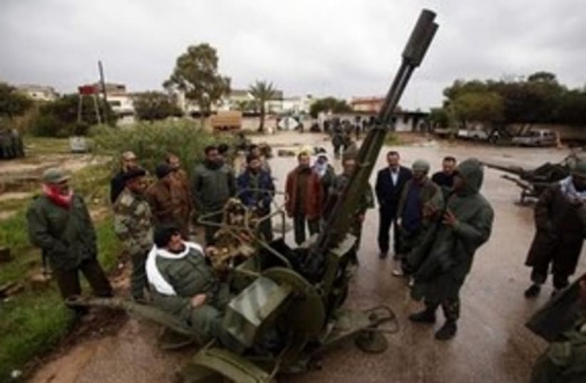 Libyan rebels using anti-aircraft gun 311 R (photo credit: Reuters)