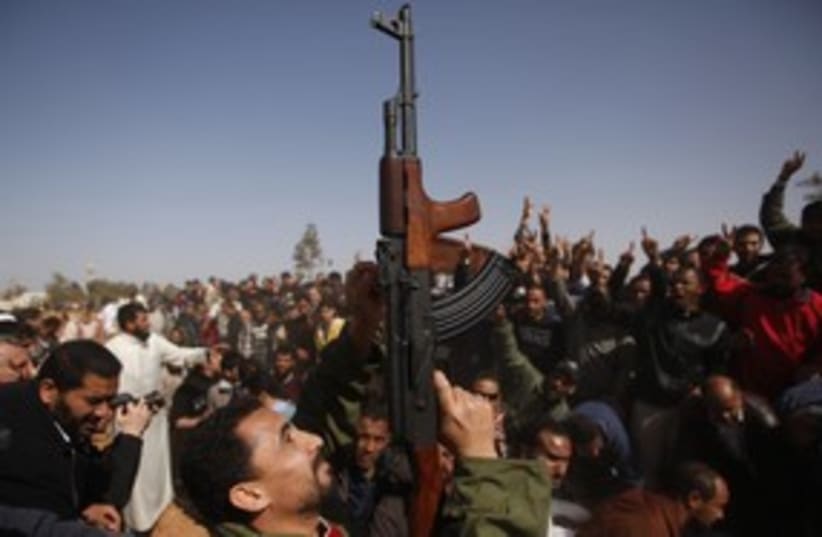 Libya Rebel with Gun (R) 311 (photo credit: REUTERS/Suhaib Salem)