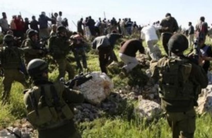 Clashes settlers Palestinians IDF soldiers 311 R (photo credit: Reuters/Nayef Hashlamoun)