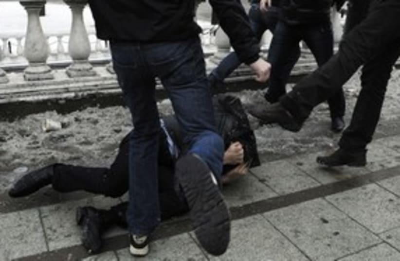 Xenophobia - man getting beaten kicked 311 R (photo credit: REUTERS)